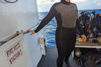 Our tester in the Mares Graph-Flex wetsuit, showing its grey chest panel, on a dive boat deck