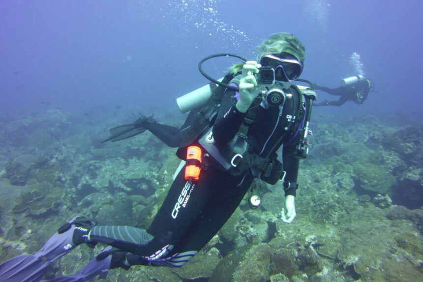Cressi Bahia Flex Wetsuit On A Warm Water Dive DIVEIN tester in the Cressi Bahia Flex wetsuit filming with a camera over a warm-water reef