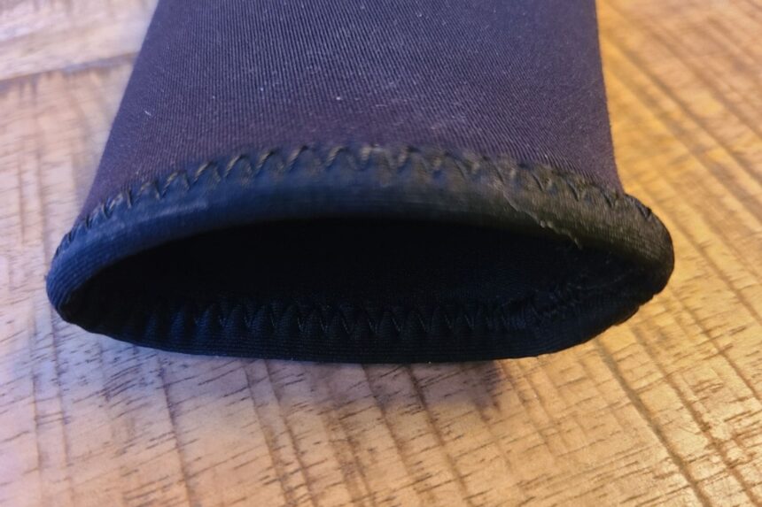 Close-up of the stitched wrist cuff and inner seal on the Akona Back Zip Classic wetsuit sleeve