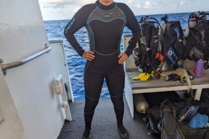 DIVEIN tester wearing the Akona back-zip classic womens wetsuit on a dive boat deck