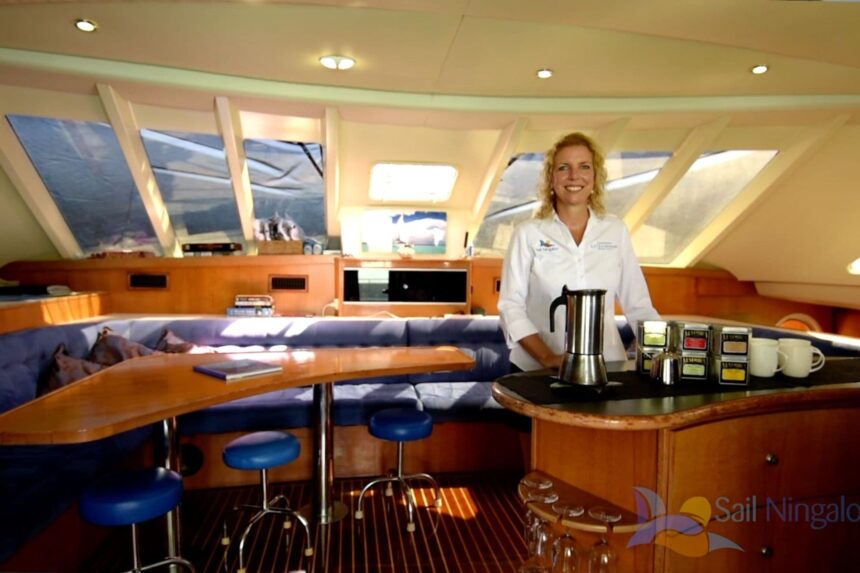 A crew member preparing coffee at the galley counter aboard the Shore Thing