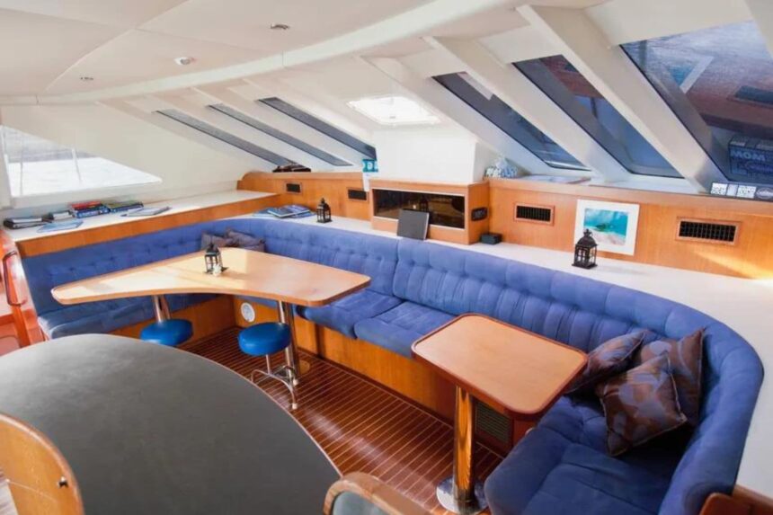 The blue upholstered salon lounge aboard the Shore Thing catamaran