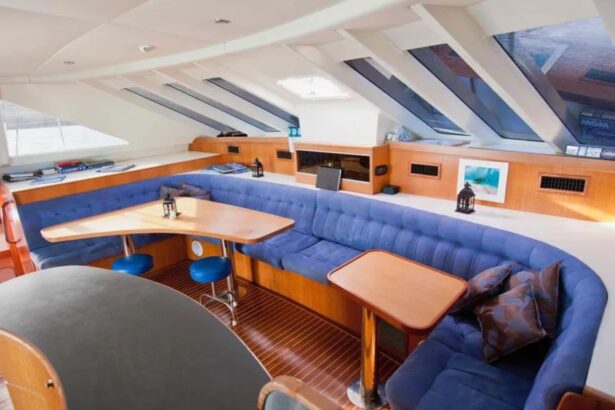 The blue upholstered salon seating area aboard the Shore Thing catamaran