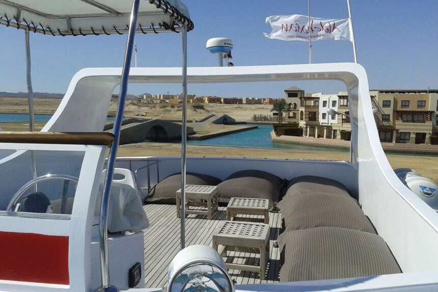 Shaded seating area on the upper deck with a marina view beyond