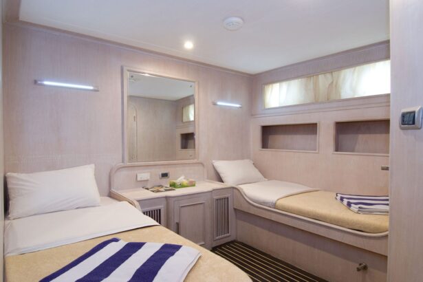 Twin bed cabin aboard the Aldebaran with a bedside mirror