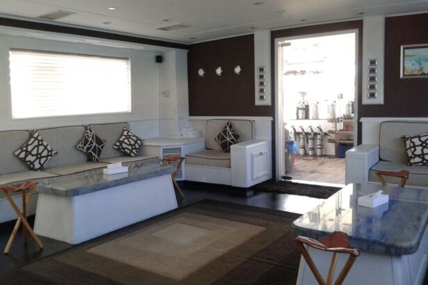 Salon seating area aboard the Aldebaran with dive tanks visible through the doorway