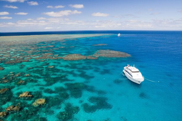 Aerial view of the Great Barrier Reef with a liveaboard anchored offshore