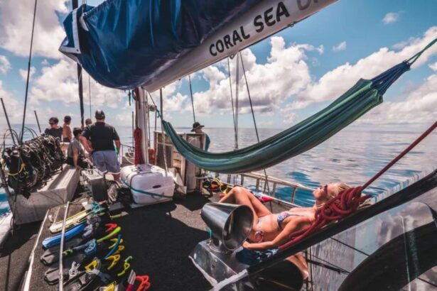 Guests relaxing in hammocks and lounging on the Coral Sea Dreaming's deck