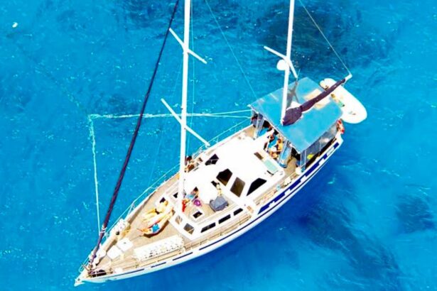 Aerial view of the Coral Sea Dreaming sailboat anchored in bright blue water