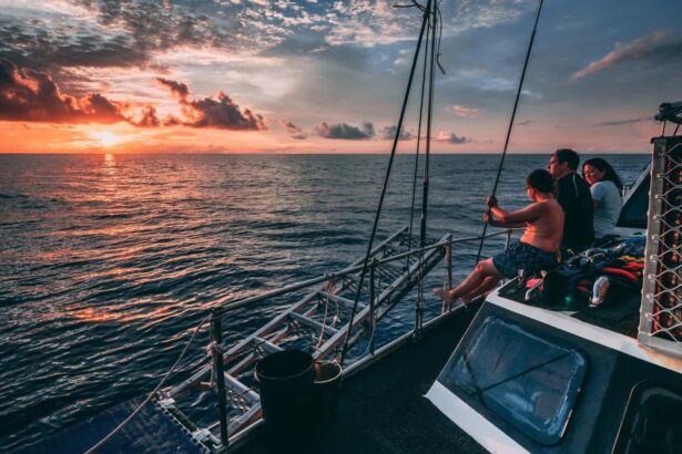 A family watching the sunset from the deck of a liveaboard at sea
