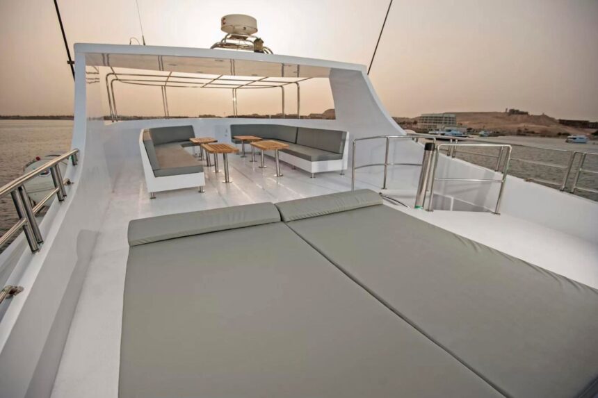 Sun deck loungers and shaded seating on the Discovery II at dusk