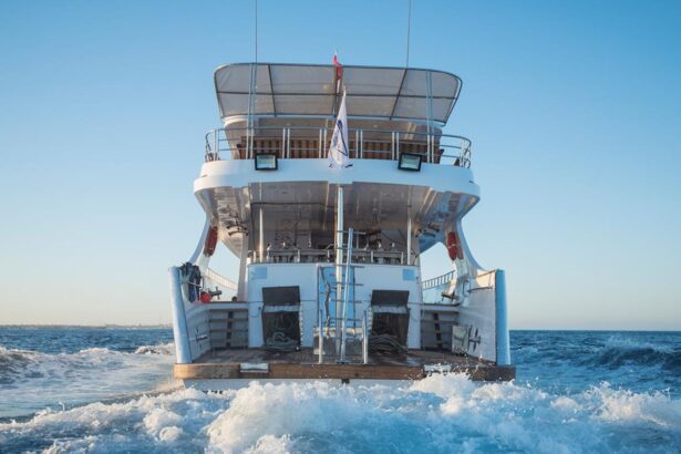 Discovery II liveaboard motoring away with its wake churning behind the stern