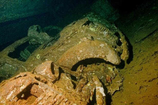 Corroded metal wreckage encrusted with marine growth on the seabed