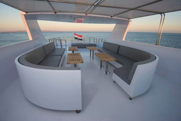 Curved shaded lounge seating on the upper deck at dusk with an Egyptian flag flying
