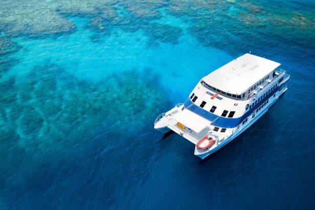 Aerial view of the OceanQuest catamaran moored beside coral reef shallows
