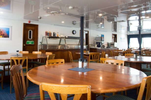 Dining room aboard OceanQuest with blue and cream upholstered chairs set at long tables