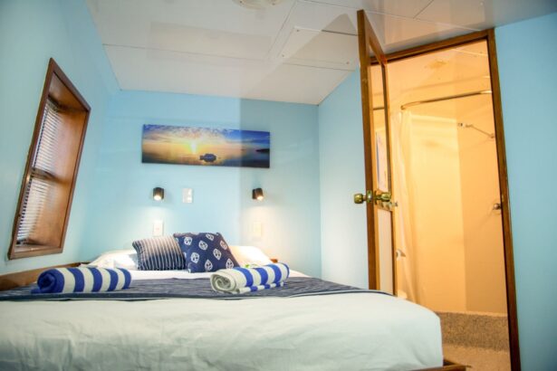 Twin cabin bedroom aboard OceanQuest with a framed reef photo above the bed