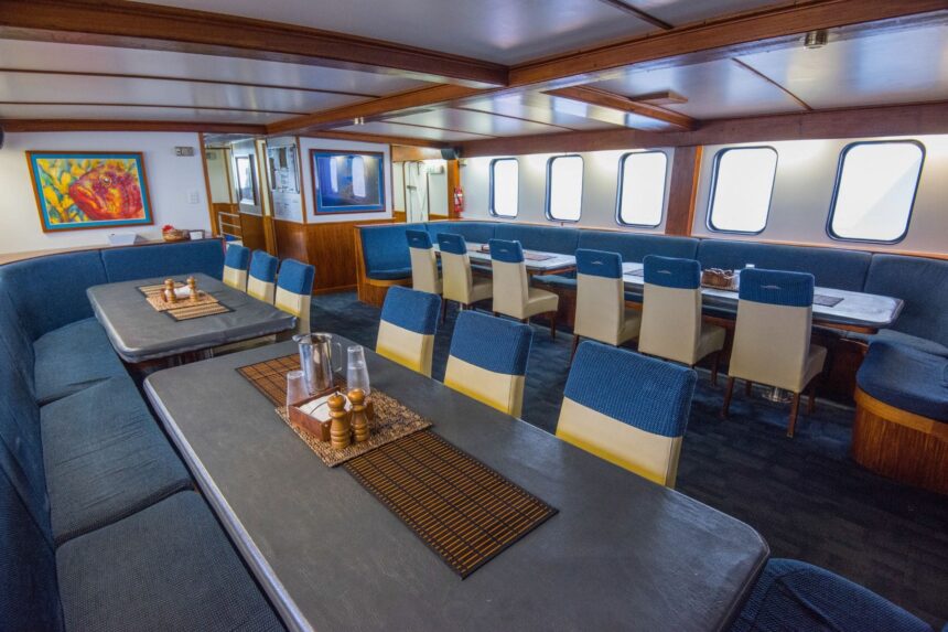 Dining room aboard Spirit of Freedom with blue booth seating and colorful artwork