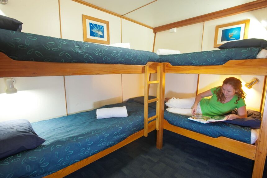 Guest reading on a bunk bed in a cabin aboard Spirit of Freedom