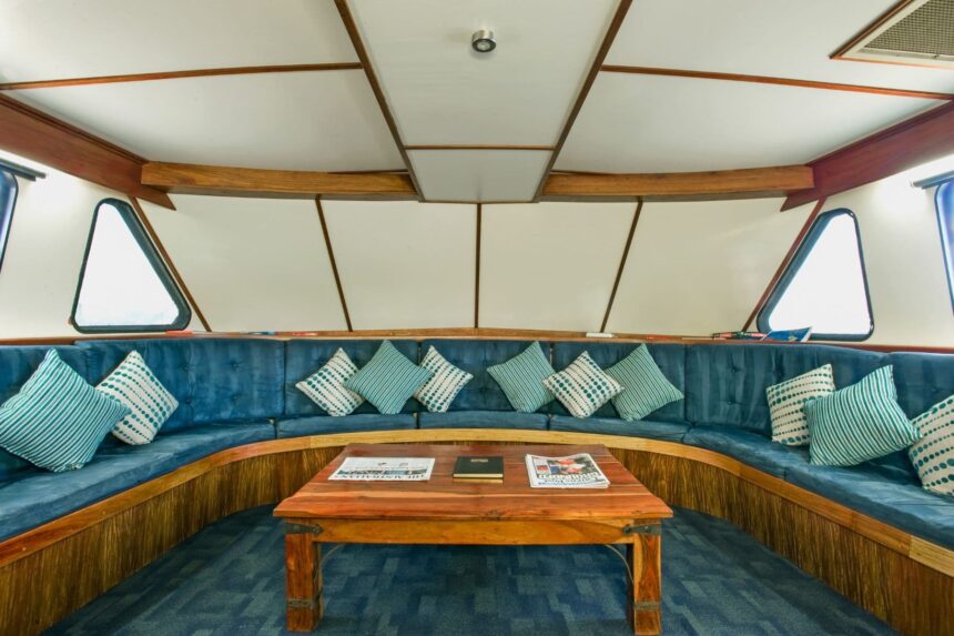 Curved blue lounge seating with cushions in the Spirit of Freedom salon