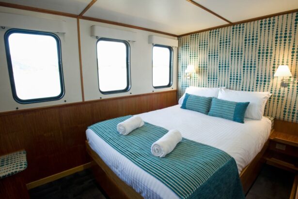Ensuite cabin aboard the Spirit of Freedom with a made-up double bed and portholes