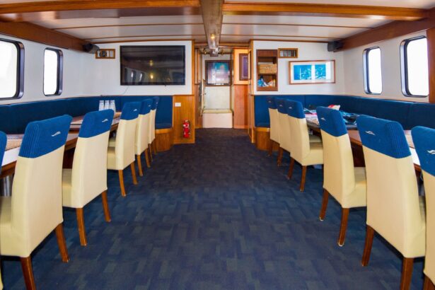 Rows of dining chairs and tables in the liveaboard's onboard dining area