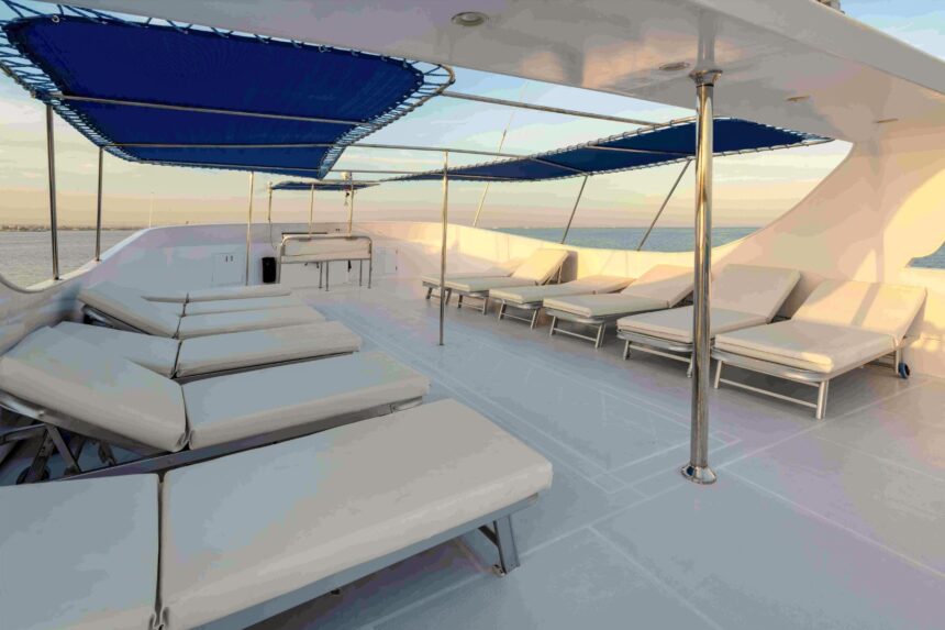 Rows of cushioned sun loungers under shade canopies on the sundeck