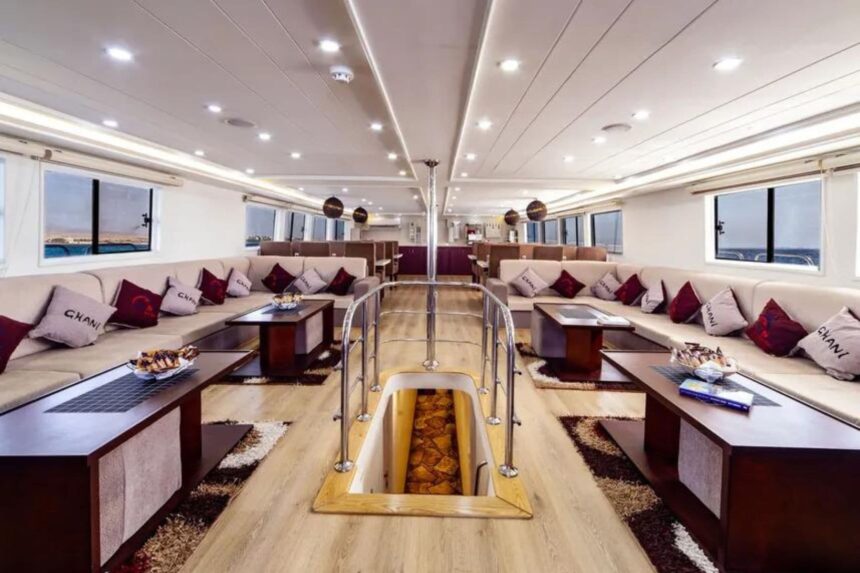 Spacious liveaboard salon with cream sofas and patterned pillows