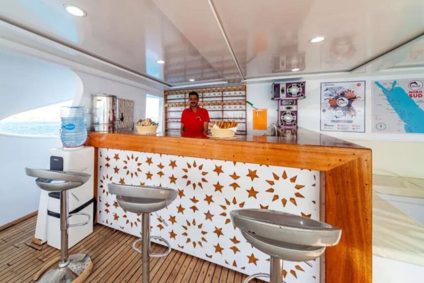Crew member serving snacks from the onboard bar counter