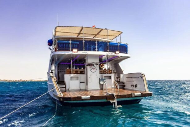 Liveaboard yacht anchored in calm turquoise water, stern view