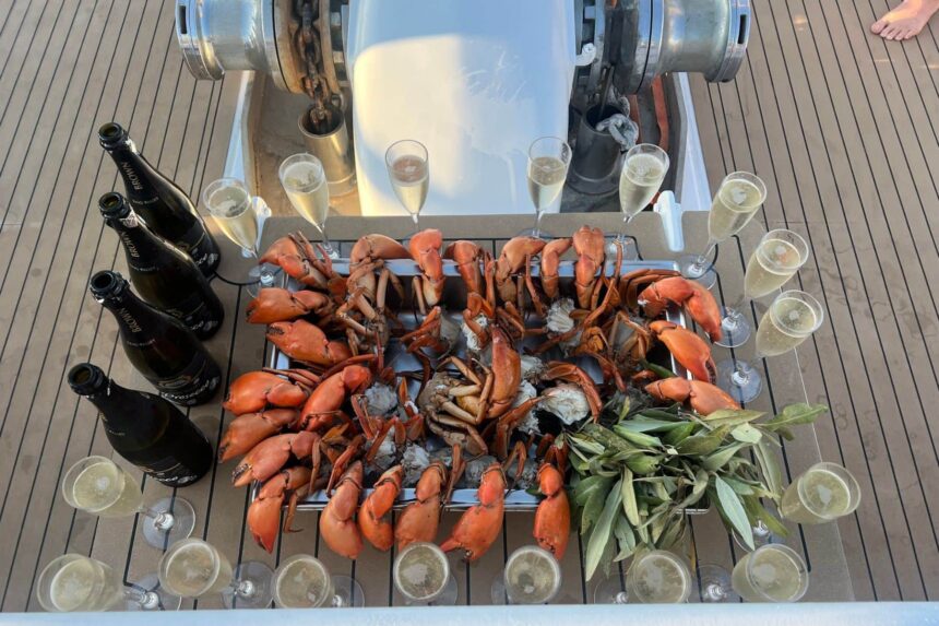 Aerial view of a mud crab platter served with champagne on deck