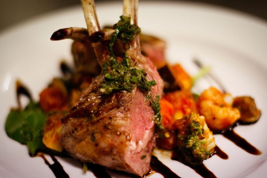 Herb crusted rack of lamb plated aboard MV Great Escape