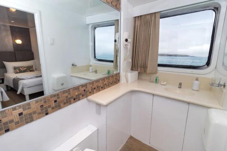 Cabin bathroom with mirror, sink, and ocean view aboard Galaxy Diver II