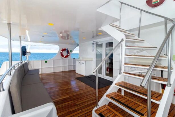 Rear deck with stairs and cushioned bench seating aboard Galaxy Diver II