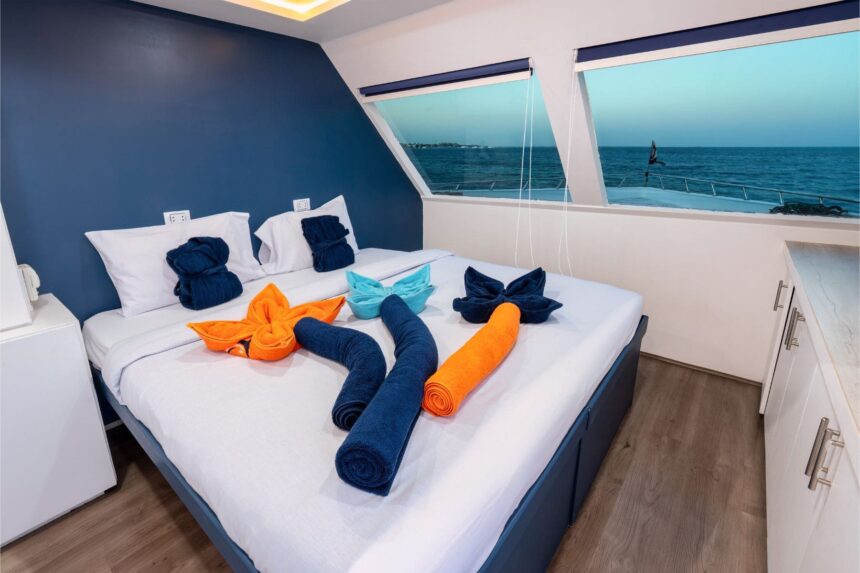 Cabin bedroom with towel art on the bed aboard Titan