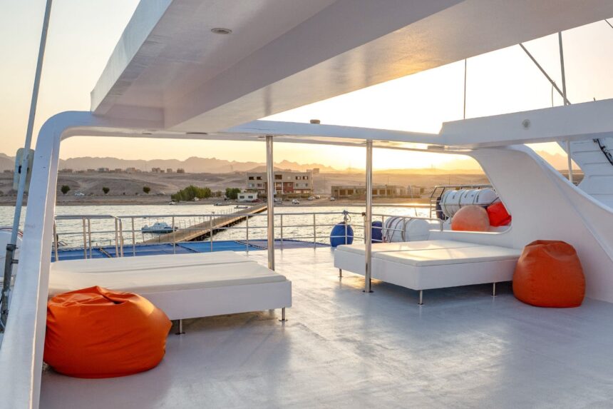 Sun deck with orange bean bags overlooking the harbor at sunset aboard Titan