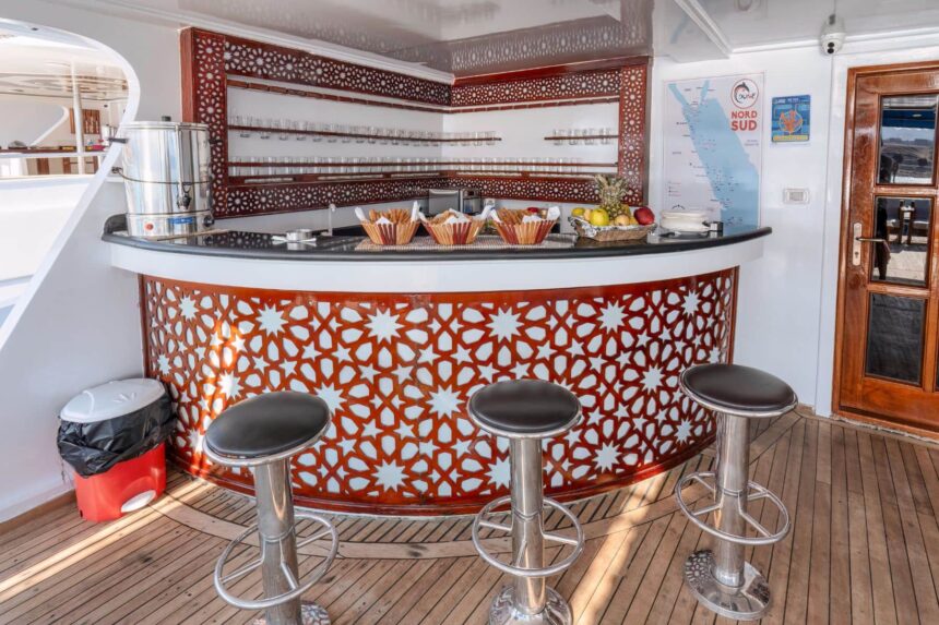 Ornate red mosaic bar counter with snacks aboard Titan