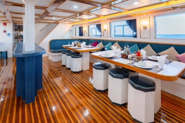 Dining salon with blue pillars and tables set for guests aboard Titan