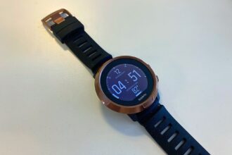 Suunto D5 dive computer with copper bezel and black strap showing the time and water temperature