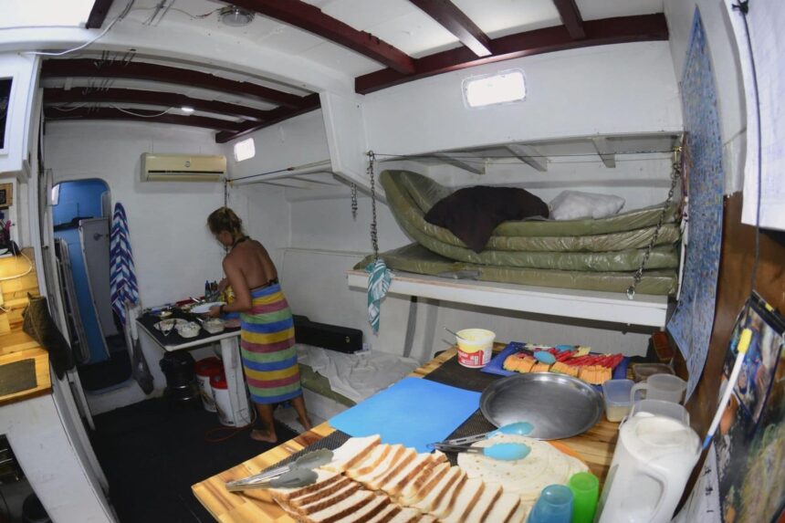 Sv Rum Runner Galley Prep Crew member preparing sandwiches and snacks in the galley of the SV Rum Runner