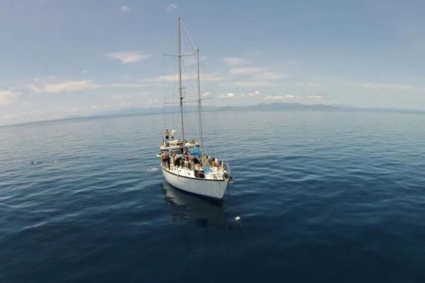 The SV Rum Runner sailing catamaran anchored offshore near Cairns with guests aboard