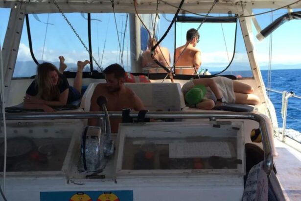 Guests relaxing on the sun-drenched deck of the SV Rum Runner sailing catamaran