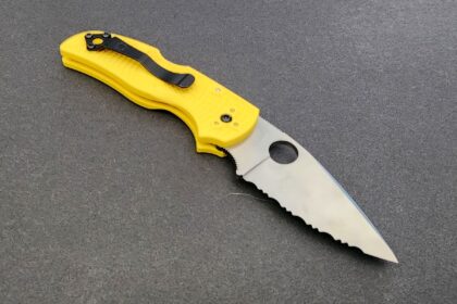 Spyderco Native 5 Salt folding dive knife open, yellow handle with fully serrated blade and thumb hole