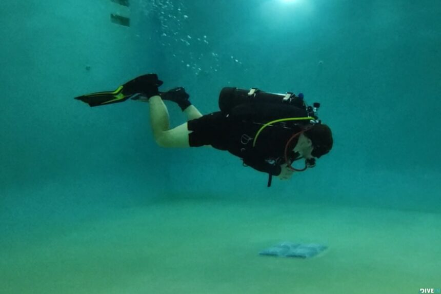 Our tester swimming in full scuba gear across a pool, testing the TUSA Hyflex Switch fins