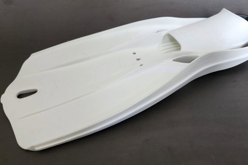 Full white TUSA Travel Right paddle fin shown from above with vents cut into the blade