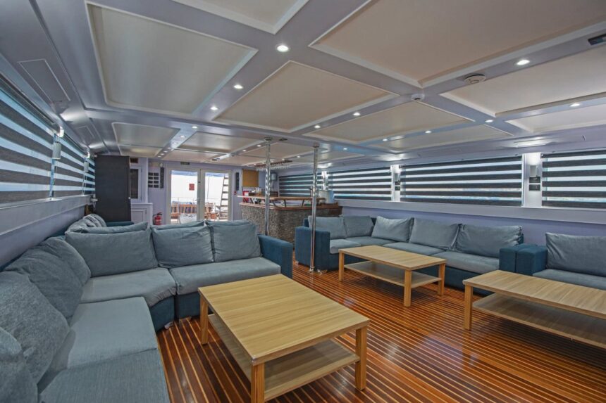 Covered outdoor lounge on the Blue Horizon with blue sofas overlooking the sea