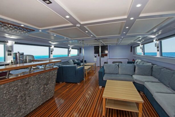 Indoor lounge and bar area aboard the Blue Horizon with wood paneling and blue sofas