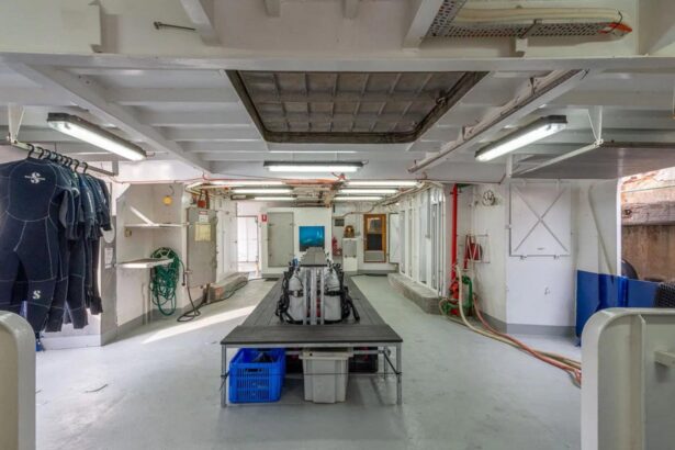 Dive gear room aboard the Rodney Fox with hanging wetsuits and tanks ready for use