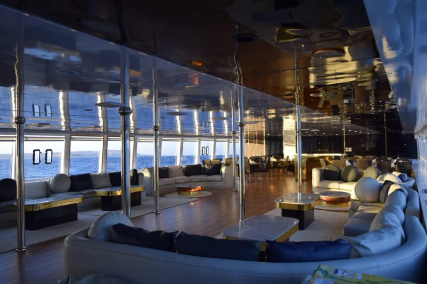 Twin cabin aboard the Hammerhead II with a wood accent headboard and lit reading nook
