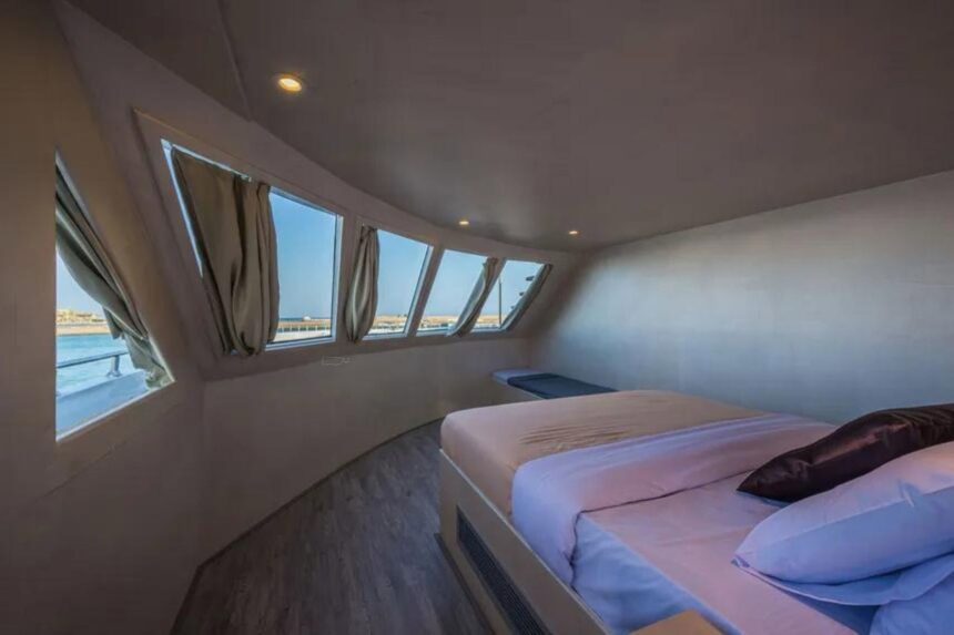 Formal lounge and dining area aboard the Hammerhead II with gold accents and leather sofas